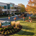Workers performing seasonal grounds cleanup on commercial property